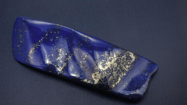 Lapis Lazuli. This striking freeform carving displays a lovely shade of blue along with attractive golden pyrite accents. - Robert Weldon, courtesy Gary Bowersox