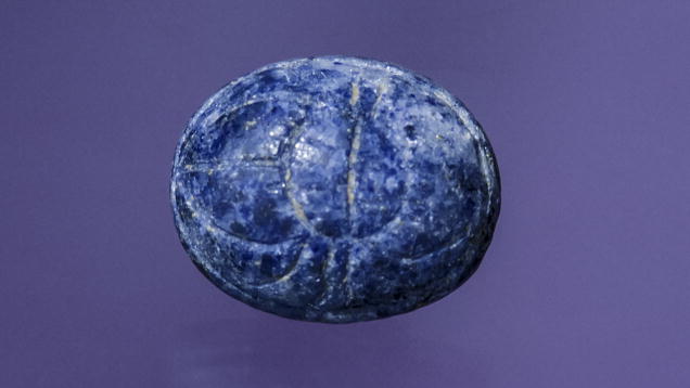 Lapis Lazuli. This lapis cabochon features the ancient symbol of a scarab beetle carved into its surface. - Maha Tannous