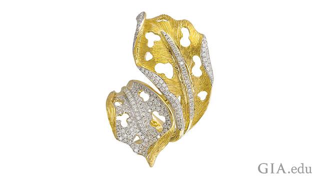 Photograph of gold ring shaped like a leaf with many melee stones set in various areas. Photograph of gold ring shaped like a leaf with many melee stones set in various areas.