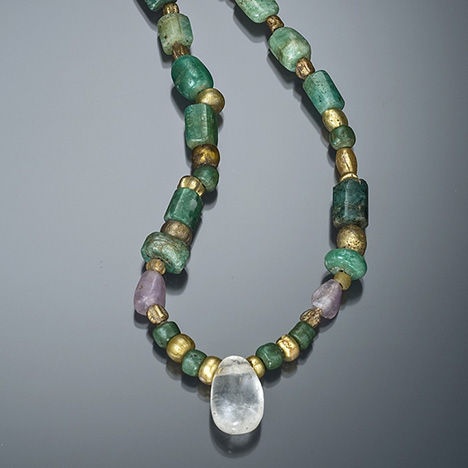 A quartz bead is the featured stone in this ancient Egyptian necklace. The strand consists of emerald, amethyst, and gold faience (a glazed ceramic). – Robert Weldon, on loan from the Royal Ontario Museum, Toronto, Canada A quartz bead is the featured stone in this ancient Egyptian necklace. The strand consists of emerald, amethyst, and gold faience (a glazed ceramic). – Robert Weldon, on loan from the Royal Ontario Museum, Toronto, Canada