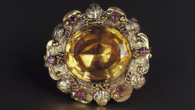 A brooch from the Victorian era features an oval citrine with six ruby accent stones. - GIA & Tino Hammid A brooch from the Victorian era features an oval citrine with six ruby accent stones. - GIA & Tino Hammid