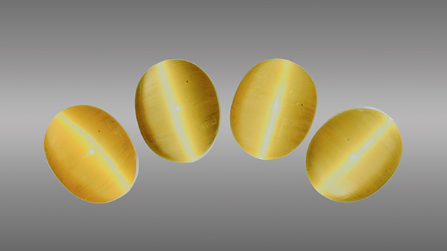 Four cat’s-eye heliodor cabochons.