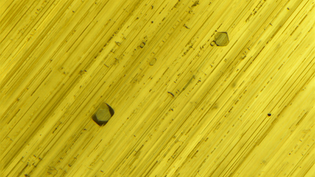 Blue octahedral crystals visible under fiber-optic illumination.