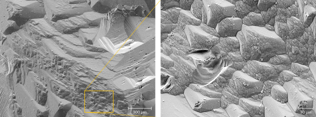 Figure 10. SEM image (left) of the edge between two prism faces, forming triangular hillocks, magnified on the right.