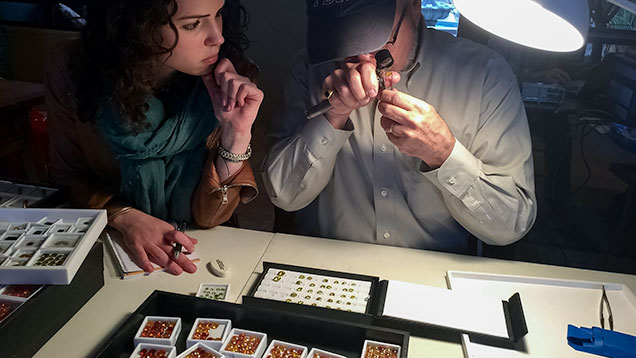 JTV staff looks at a dealer’s gemstones JTV staff looks at a dealer’s gemstones