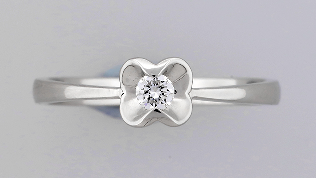 CVD synthetic melee diamond mounted in ring. Figure 1. One of the round-cut melee mounted in this ring was identified as a CVD synthetic diamond. Photo by Johnny Leung.