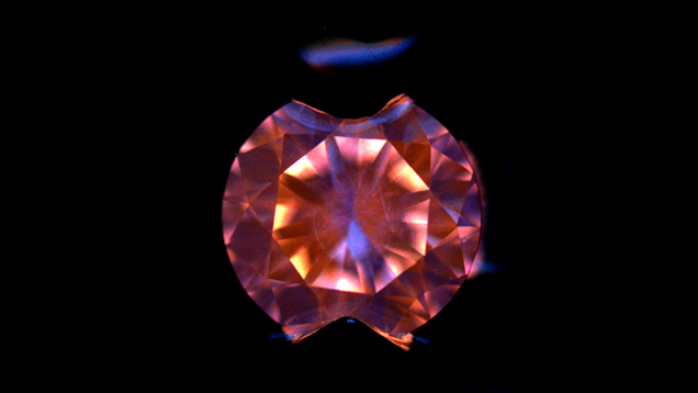 DiamondView of CVD synthetic melee diamond. Figure 3. DiamondView imaging showed strong orange fluorescence with small irregular areas of blue fluorescence, a typical feature of as-grown CVD synthetic diamond. Photo by Carmen Lo.