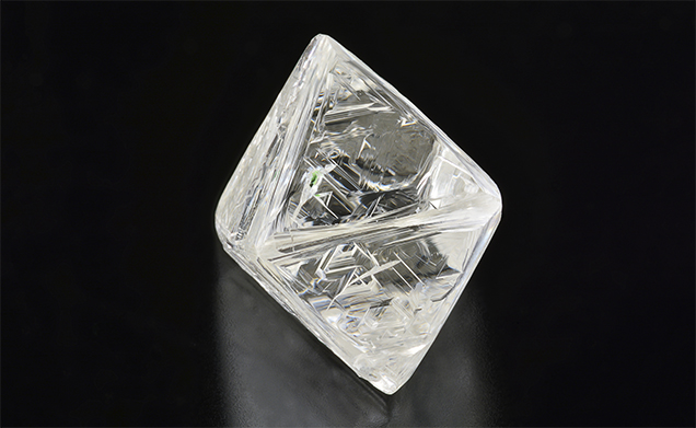 Bright green chromium diopside inclusion in diamond octahedron.