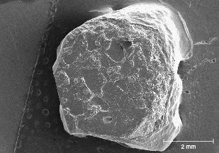 Figure 24. SEM image showing the surface of a Rock Creek sapphire. The hillocks on the surface are typical of Rock Creek sapphire. Image by Richard Berg (modified from Berg, 2022). Figure 24. SEM image showing the surface of a Rock Creek sapphire. The hillocks on the surface are typical of Rock Creek sapphire. Image by Richard Berg (modified from Berg, 2022).