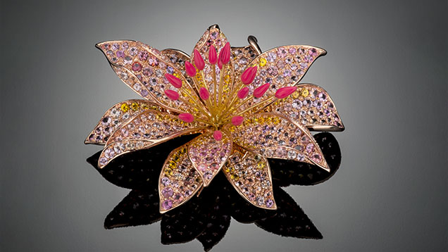 Figure 3. The “Bitterroot Flower” brooch by Paula Crevoshay contains nearly 400 Montana sapphires: 79 pink (6.03 carats total), 116 yellow (7.46 carats total), and 202 additional fancy-color (16.26 carats total). Photo by Robert Weldon; courtesy of Paula Crevoshay. Figure 3. The “Bitterroot Flower” brooch by Paula Crevoshay contains nearly 400 Montana sapphires: 79 pink (6.03 carats total), 116 yellow (7.46 carats total), and 202 additional fancy-color (16.26 carats total). Photo by Robert Weldon; courtesy of Paula Crevoshay.