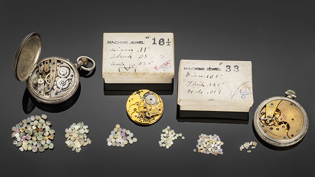 Figure 6. Watch bearings fashioned out of Montana sapphires in various stages of completion. The leftmost pile contains rough sapphires ready for fabrication, and the pile second from the left contains sapphires ground to wafers of standard thickness to be drilled out to produce bearings. The four piles to the right show finished natural sapphire watch bearings. Photo by Robert Weldon; courtesy of the Sapphire Gallery. Figure 6. Watch bearings fashioned out of Montana sapphires in various stages of completion. The leftmost pile contains rough sapphires ready for fabrication, and the pile second from the left contains sapphires ground to wafers of standard thickness to be drilled out to produce bearings. The four piles to the right show finished natural sapphire watch bearings. Photo by Robert Weldon; courtesy of the Sapphire Gallery.