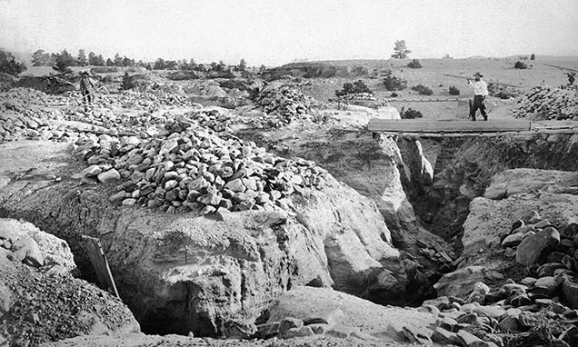 Figure 7. Mining operation at Dana’s Bar. The piles of rock are from the trenches below. Photo by Edgar H. Train between 1870 and 1879, Lot 026 B3F15.03 Dana’s Bar, Montana Historical Society Photograph Archives. Figure 7. Mining operation at Dana’s Bar. The piles of rock are from the trenches below. Photo by Edgar H. Train between 1870 and 1879, Lot 026 B3F15.03 Dana’s Bar, Montana Historical Society Photograph Archives.