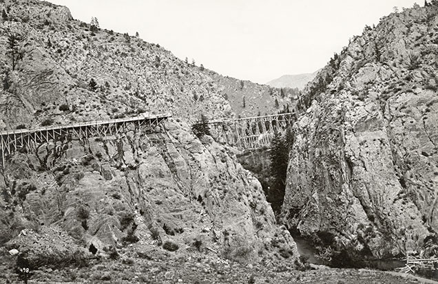 Figure 8. The flume taking water from Trout Creek to the sapphire and gold mining operations at the Missouri River. In this view, the flume is crossing Trout Creek itself, with the water taken from further upstream. Photo by W.H. Jackson during the 1869–1871 Hayden Survey. Lot 032 B5F09.03a Trout Creek Flume, Montana Historical Society Photograph Archives. Figure 8. The flume taking water from Trout Creek to the sapphire and gold mining operations at the Missouri River. In this view, the flume is crossing Trout Creek itself, with the water taken from further upstream. Photo by W.H. Jackson during the 1869–1871 Hayden Survey. Lot 032 B5F09.03a Trout Creek Flume, Montana Historical Society Photograph Archives.