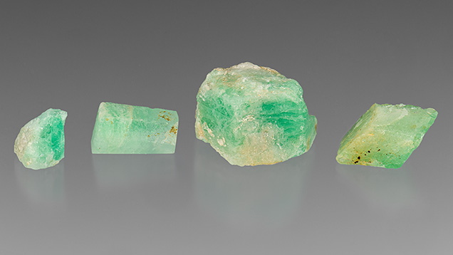 Figure 1. Emerald and beryl specimens from Newfoundland, Canada. The chip on the right has a distinct green rim in this position, on its lower right edge. Photo by Emily Lane; courtesy of Art Gardner and Terry Russell.