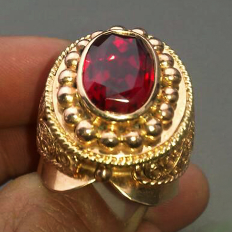 Bright red faceted ruby in a gold ring, from the large and potentially productive Snezhnoe deposit in Tajikistan. Bright red faceted ruby in a gold ring, from the large and potentially productive Snezhnoe deposit in Tajikistan.