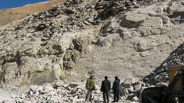 An outcrop of white marble and dumps at the corundum deposit in Snezhnoe, Tajikistan. An outcrop of white marble and dumps at the corundum deposit in Snezhnoe, Tajikistan.