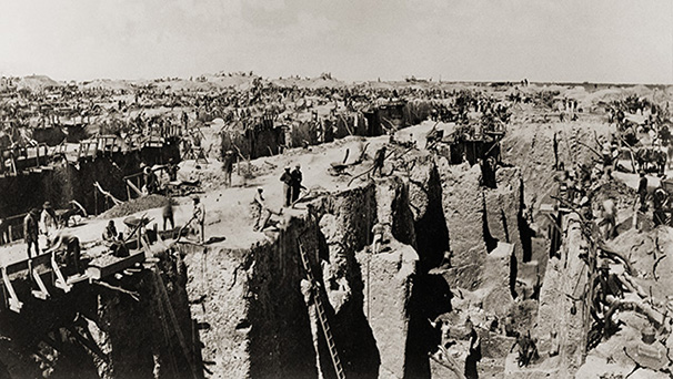 Figure B-1. Image of the haphazard mining operations at the Kimberley “Big Hole” before the consolidation of mining operations by Cecil Rhodes and Barney Barnato, and the founding of the De Beers Consolidated Mines in 1888. Each miner owned a small claim of land and sent diggings to the surface by winch and rope. They worked at different rates and left a highly irregular and dangerous surface. See also figure 1C. Figure B-1. Image of the haphazard mining operations at the Kimberley “Big Hole” before the consolidation of mining operations by Cecil Rhodes and Barney Barnato, and the founding of the De Beers Consolidated Mines in 1888. Each miner owned a small claim of land and sent diggings to the surface by winch and rope. They worked at different rates and left a highly irregular and dangerous surface. See also figure 1C.
