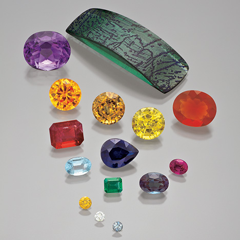 Figure 1. Synthetic alexandrite, amethyst, beryl, corundum, diamond, and fire opal. The three smallest stones are synthetic diamonds ranging from 0.06 to 0.14 ct. Photo by Robert Weldon. Figure 1. Synthetic alexandrite, amethyst, beryl, corundum, diamond, and fire opal. The three smallest stones are synthetic diamonds ranging from 0.06 to 0.14 ct. Photo by Robert Weldon.