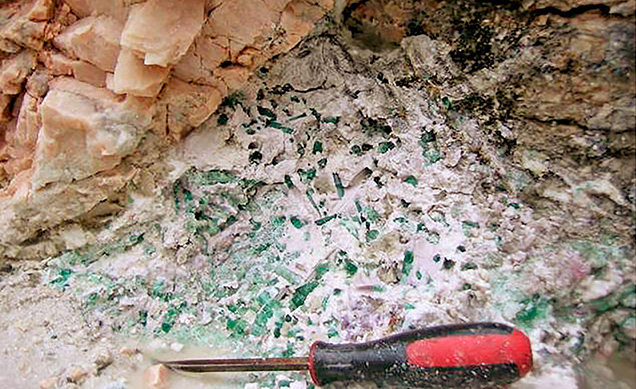 Figure 11. Colored tourmaline crystals embedded in secondary clay minerals in a pocket at the Havey pegmatite near Poland, Androscoggin County, Maine, in July 2018. Courtesy of William (Skip) Simmons. Figure 11. Colored tourmaline crystals embedded in secondary clay minerals in a pocket at the Havey pegmatite near Poland, Androscoggin County, Maine, in July 2018. Courtesy of William (Skip) Simmons.