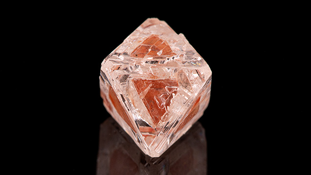 Figure 1. Weighing 2.22 ct and measuring 8.26 mm in the largest dimension, this unique diamond octahedron contains a high-relief, three-dimensional phantom visible through all eight octahedral faces. Photo by Diego Sanchez. Figure 1. Weighing 2.22 ct and measuring 8.26 mm in the largest dimension, this unique diamond octahedron contains a high-relief, three-dimensional phantom visible through all eight octahedral faces. Photo by Diego Sanchez.