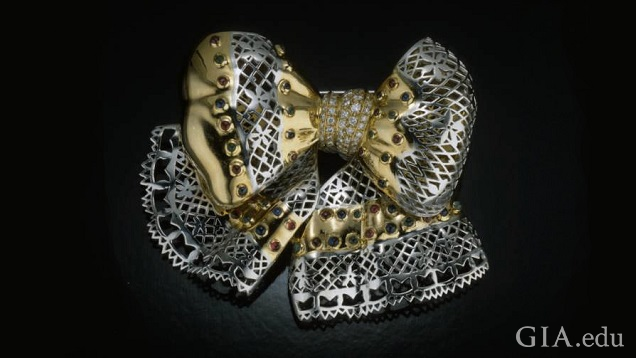 The bow section and ribbon tendrils are made from two metals – silver and gold colored. The bow section and ribbon tendrils are made from two metals – silver and gold colored.