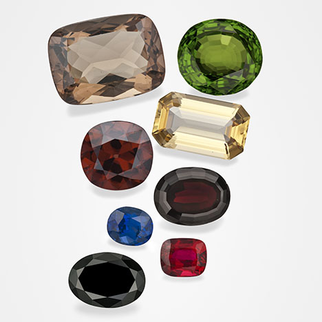 Figure 1. These examples of gem minerals that formed in magmatic environments are part of GIA’s Eduard Gübelin Collection. From top to bottom and left to right: 29.96 ct sanidine feldspar from Germany, 53.00 ct peridot from Myanmar, 11.58 ct zircon from Thailand, 20.66 ct topaz from Utah, 2.05 ct sapphire from Thailand, 18.36 ct pyrope garnet from the Czech Republic, 19.55 ct black spinel from Thailand, and 2.50 ct ruby from Thailand. Photos by Robert Weldon. Figure 1. These examples of gem minerals that formed in magmatic environments are part of GIA’s Eduard Gübelin Collection. From top to bottom and left to right: 29.96 ct sanidine feldspar from Germany, 53.00 ct peridot from Myanmar, 11.58 ct zircon from Thailand, 20.66 ct topaz from Utah, 2.05 ct sapphire from Thailand, 18.36 ct pyrope garnet from the Czech Republic, 19.55 ct black spinel from Thailand, and 2.50 ct ruby from Thailand. Photos by Robert Weldon.