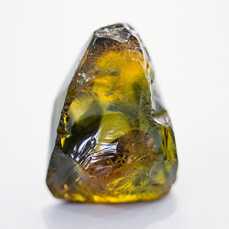 Figure 15. A rough multicolored sapphire crystal weighing more than 30 ct from the Changle region of China. Photo by Robert Weldon. Figure 15. A rough multicolored sapphire crystal weighing more than 30 ct from the Changle region of China. Photo by Robert Weldon.