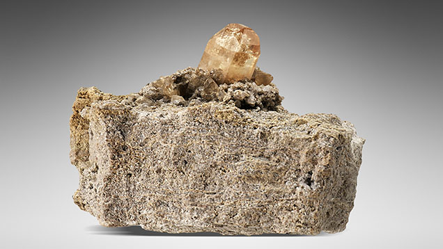 Figure 16. A topaz crystal on rhyolite matrix from the Thomas Range, Juab County, Utah. Photo by Robert Weldon. Figure 16. A topaz crystal on rhyolite matrix from the Thomas Range, Juab County, Utah. Photo by Robert Weldon.
