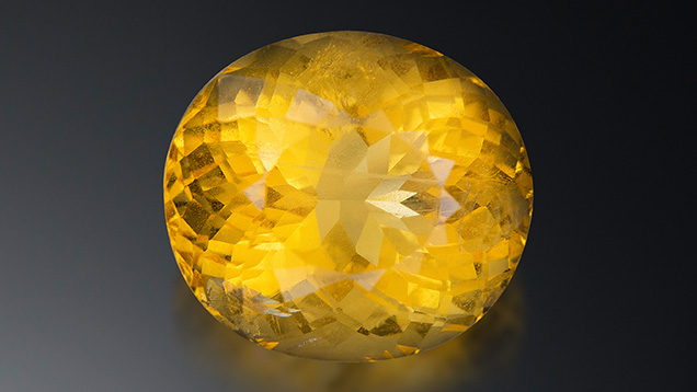 A 16.71 ct transparent orange-yellow oval sodalite measuring 17.61 × 15.74 × 12.88 mm. Photo by Lhapsin Nillapat. A 16.71 ct transparent orange-yellow oval sodalite measuring 17.61 × 15.74 × 12.88 mm. Photo by Lhapsin Nillapat.