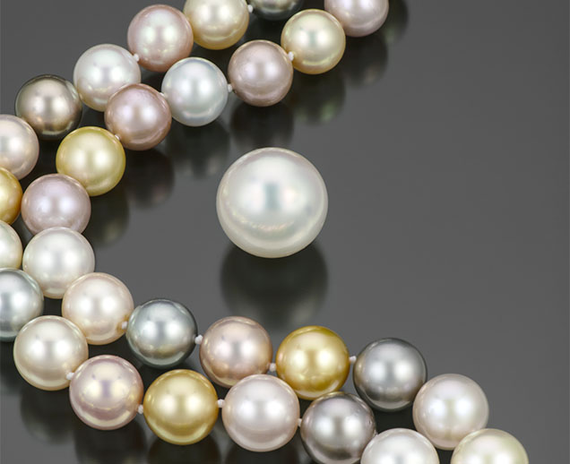 Figure 11. A mixed strand of 79 pearls ranging from 11.8 to 14.8 mm, consisting of pink Chinese freshwater, black Tahitian, golden Indonesian, and white Australian bead cultured pearls. Also pictured is an exceptionally large 20.4 mm South Sea bead cultured pearl weighing 12 g. Photo by Robert Weldon; courtesy of Yoko London. Figure 11. A mixed strand of 79 pearls ranging from 11.8 to 14.8 mm, consisting of pink Chinese freshwater, black Tahitian, golden Indonesian, and white Australian bead cultured pearls. Also pictured is an exceptionally large 20.4 mm South Sea bead cultured pearl weighing 12 g. Photo by Robert Weldon; courtesy of Yoko London.