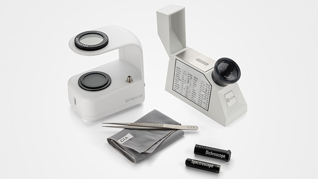 Figure 6. Clockwise from top left: A polariscope, refractometer, dichroscope, and spectroscope are shown with a gem cloth and tweezers. Photo by Emily Lane. Figure 6. Clockwise from top left: A polariscope, refractometer, dichroscope, and spectroscope are shown with a gem cloth and tweezers. Photo by Emily Lane.