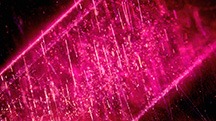 Figure 1. This Mozambique ruby contains needles and bands of particles before heating (left). The inclusions did not show any signs of alteration after heating at 900°C for 5 hours in air (right). However, the development of the 3309 cm–1 series in the FTIR spectrum was detected in this stone after heating, providing evidence of low-temperature heat treatment. Photomicrographs by Suwasan Wongchacree; field of view 1.75 mm.