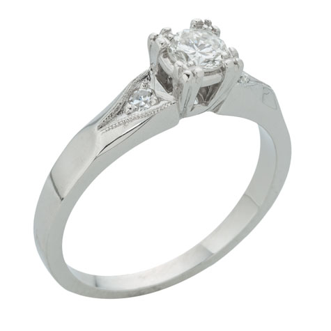 Perspective view of a platinum solitaire with a decorative shank featuring sides stones and millgrain detail Perspective view of a platinum solitaire with a decorative shank featuring sides stones and millgrain detail