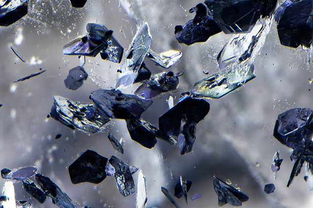 Hexagonal molybdenite crystals in phantom plane of quartz. Hexagonal molybdenite crystals in phantom plane of quartz.