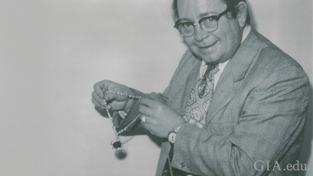 Man holds the Hope Diamond necklace.